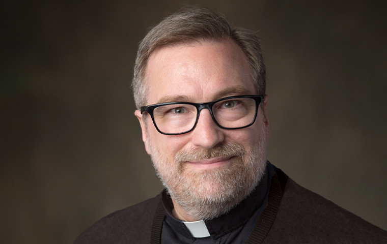 Headshot of Fr. Joseph Mueller, S.J.,  in collar image link to story