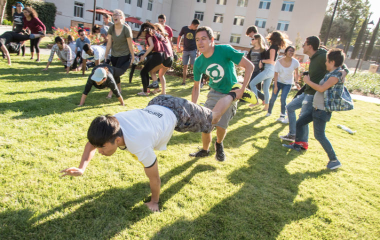 Kelby Uebelhor pictured in a wheelbarrow race during LEAD Week at SCU