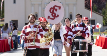 students with instruments walking in front of the Mission Church 