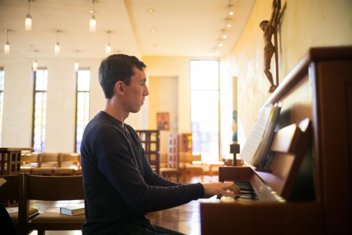 A person playing the piano inside a church.