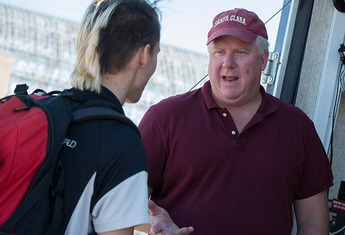Chris Kitts speaks with a student in one of the on-campus garages
