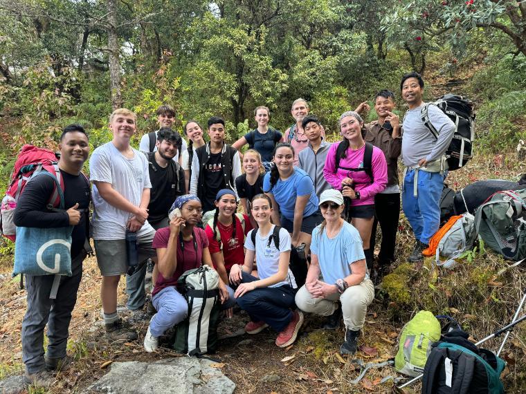 Group of students, faculty and trekking guides in rural Nepal.