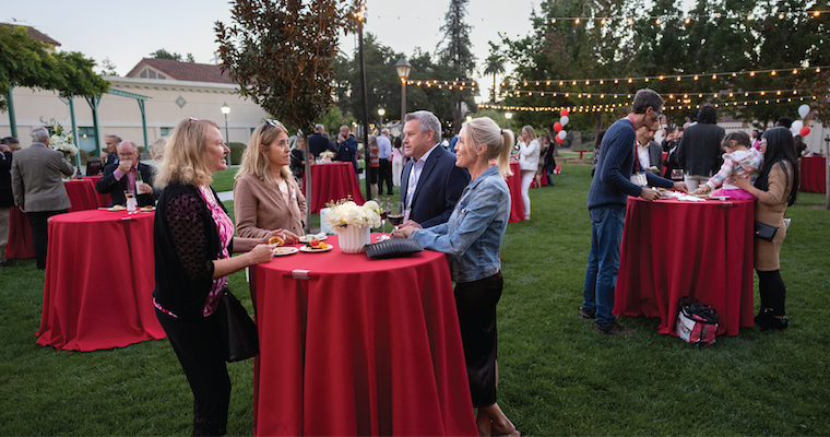 Leavey alumni socializing on the Lucas Hall lawn