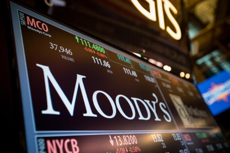 A monitor displays Moody's Corp. signage on the floor of the New York Stock Exchange (NYSE) in New York, U.S., on Monday, March 27, 2017.  Photographer: Michael Nagle/Bloomberg. image link to story