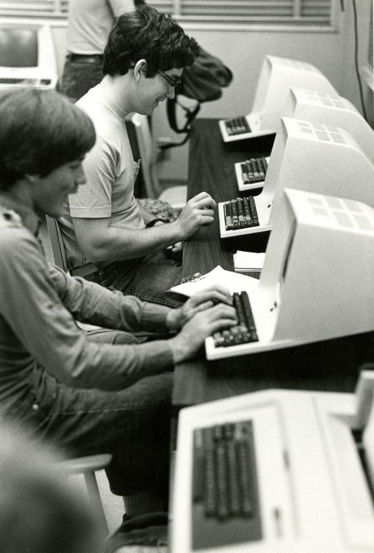 Students of the Leavey School of Business work on early computers.