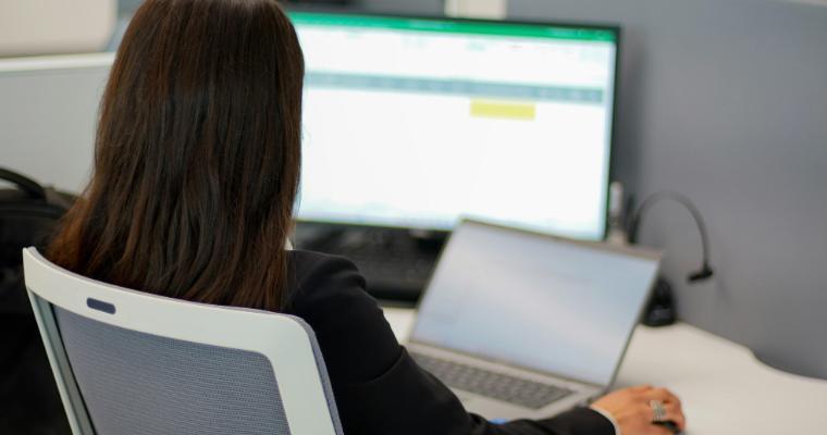 Businesswoman looking at spreadsheets on laptop and monitor image link to article