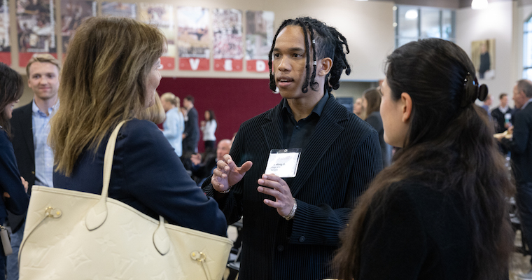 SCU student networking with industry professionals at Leavey's Real Estate Symposium