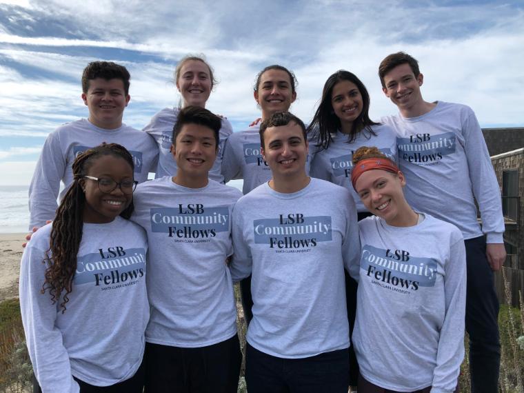 Alt text: Group photo of eight people wearing 