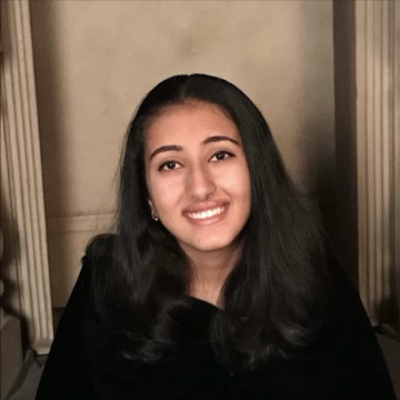 Portrait of a smiling person against a neutral background.