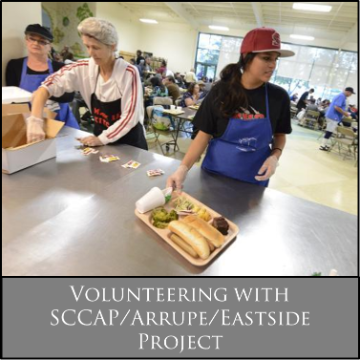 Volunteers preparing food trays at sccap arrupe eastside project.