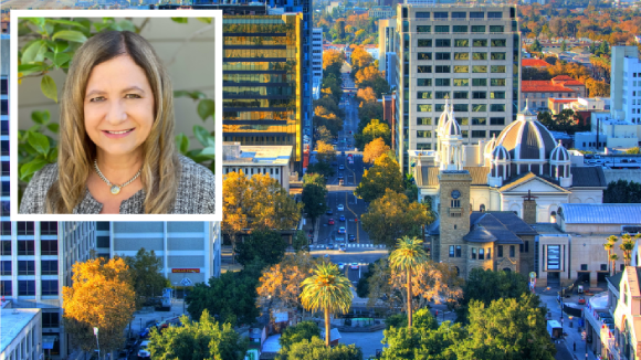 An aerial shot of San Jose, CA. An overlaid square in the upper left corner has an image of a smiling woman.