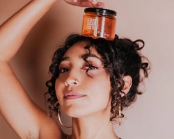 Woman with a hand on top of her head.