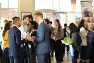 Group of well-dressed students talking to each other