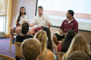 three people from santa clara university leading a conversation in front of a group of people