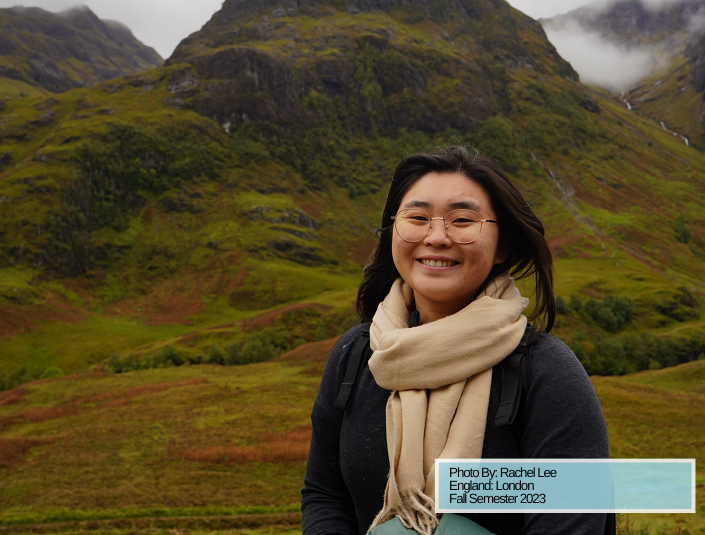 Decorative; student smiling in front of a mountain landscape