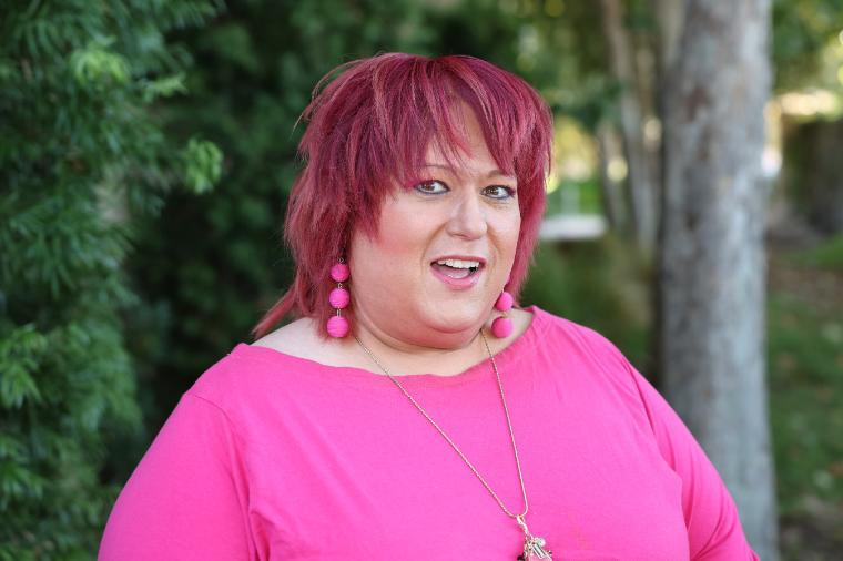 A woman in a bright pink long-sleeved shirt