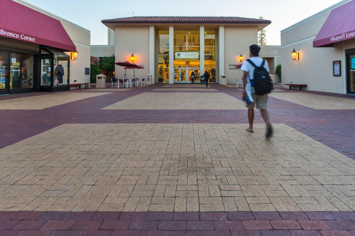 A student walking to the entrance of the Benson Memorial Center. 
