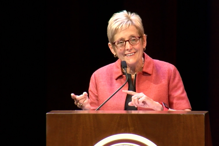 SCU President Julie Sullivan speaking at a podium