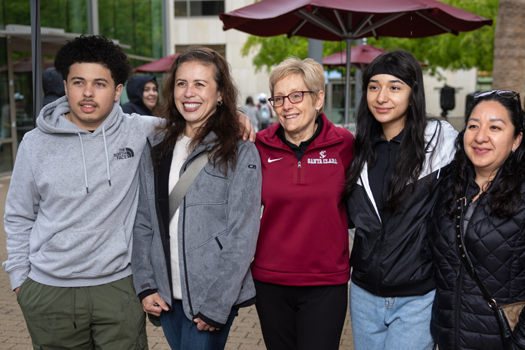 SCU President Julie Sullivan poses for a picture with two new students and their parent