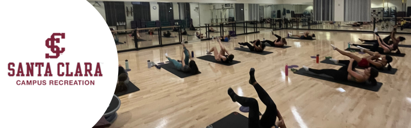 Picture shows Fitness class, participants doing ab exercise