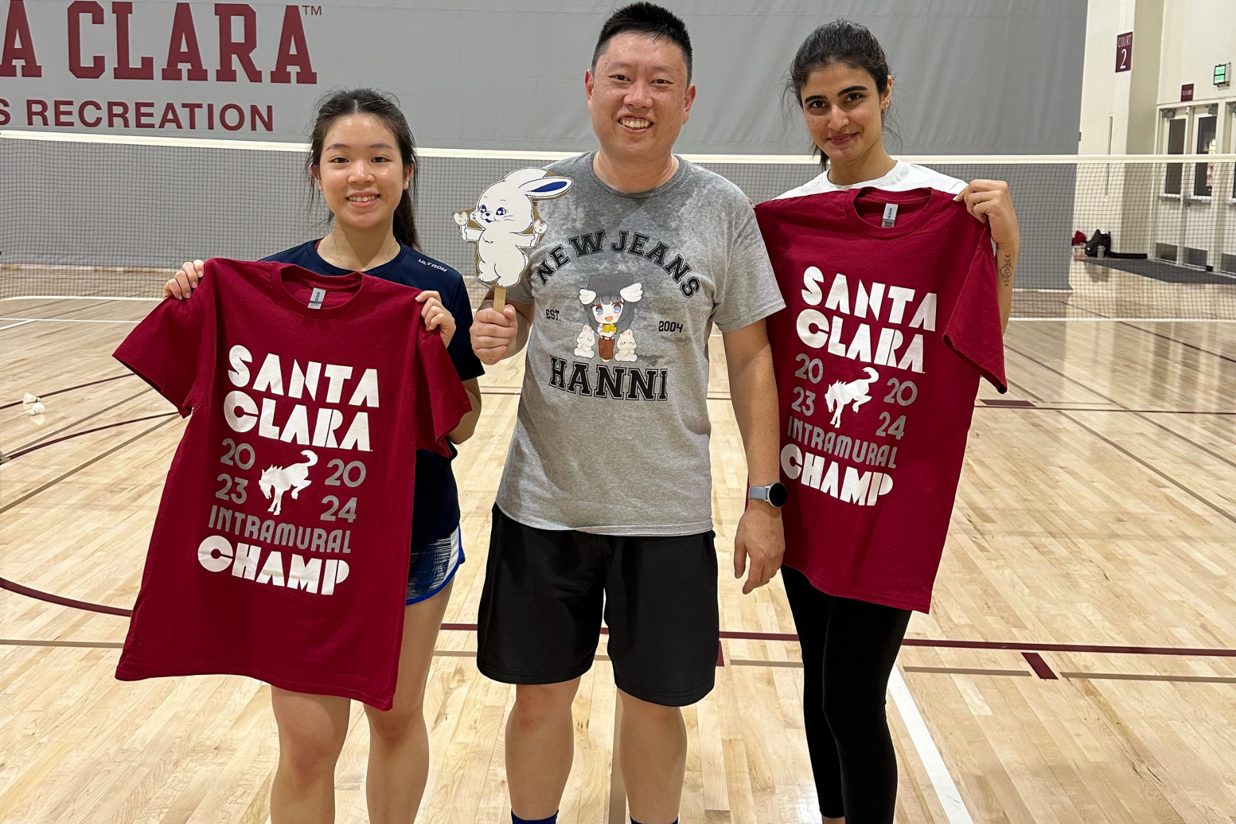 Spring 2023 pickleball winners Angel and Tony posing for photo with IM champ t-shirts