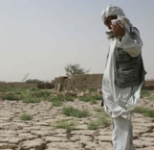 picture of Afghan person standing on parched earth