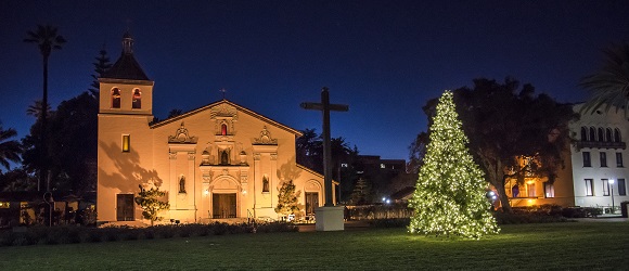 Santa Clara Mission with a lit Christmas Tree in front