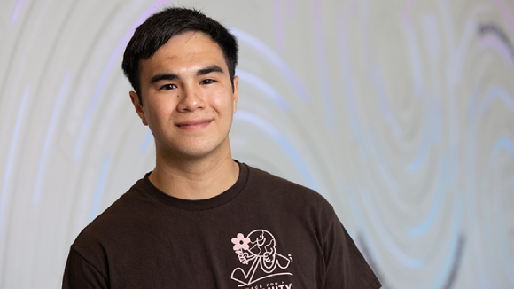 A young smiling man of Asian descent in a black t-shirt