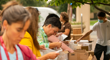 People helping assemble hygiene kits. 