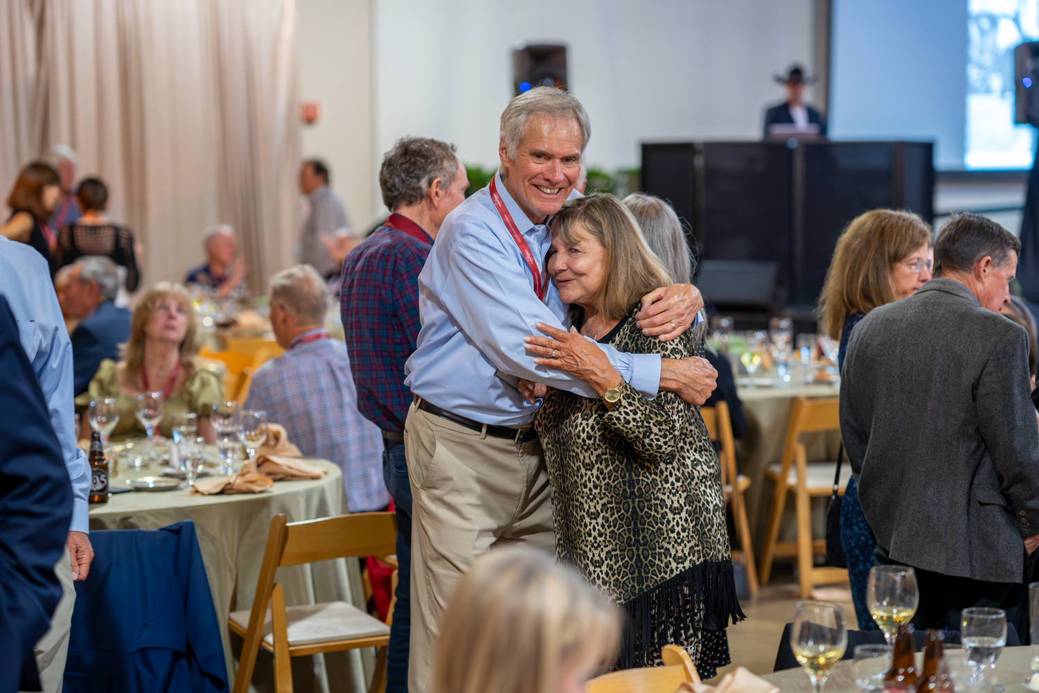 Two alumni hug at the Gianera Lunch