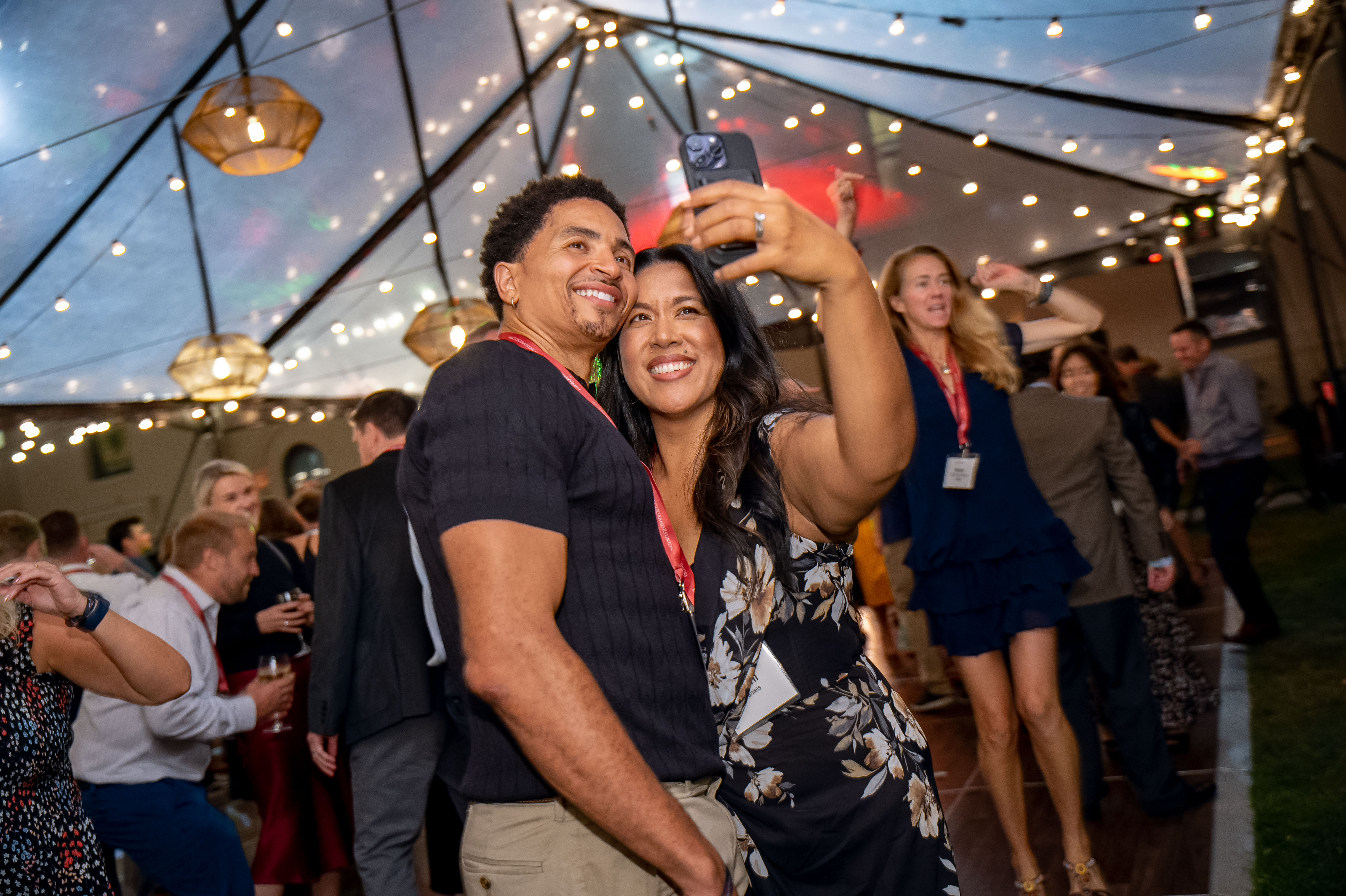 Two alumni taking a selfie on the dance floor at Grand Reunion