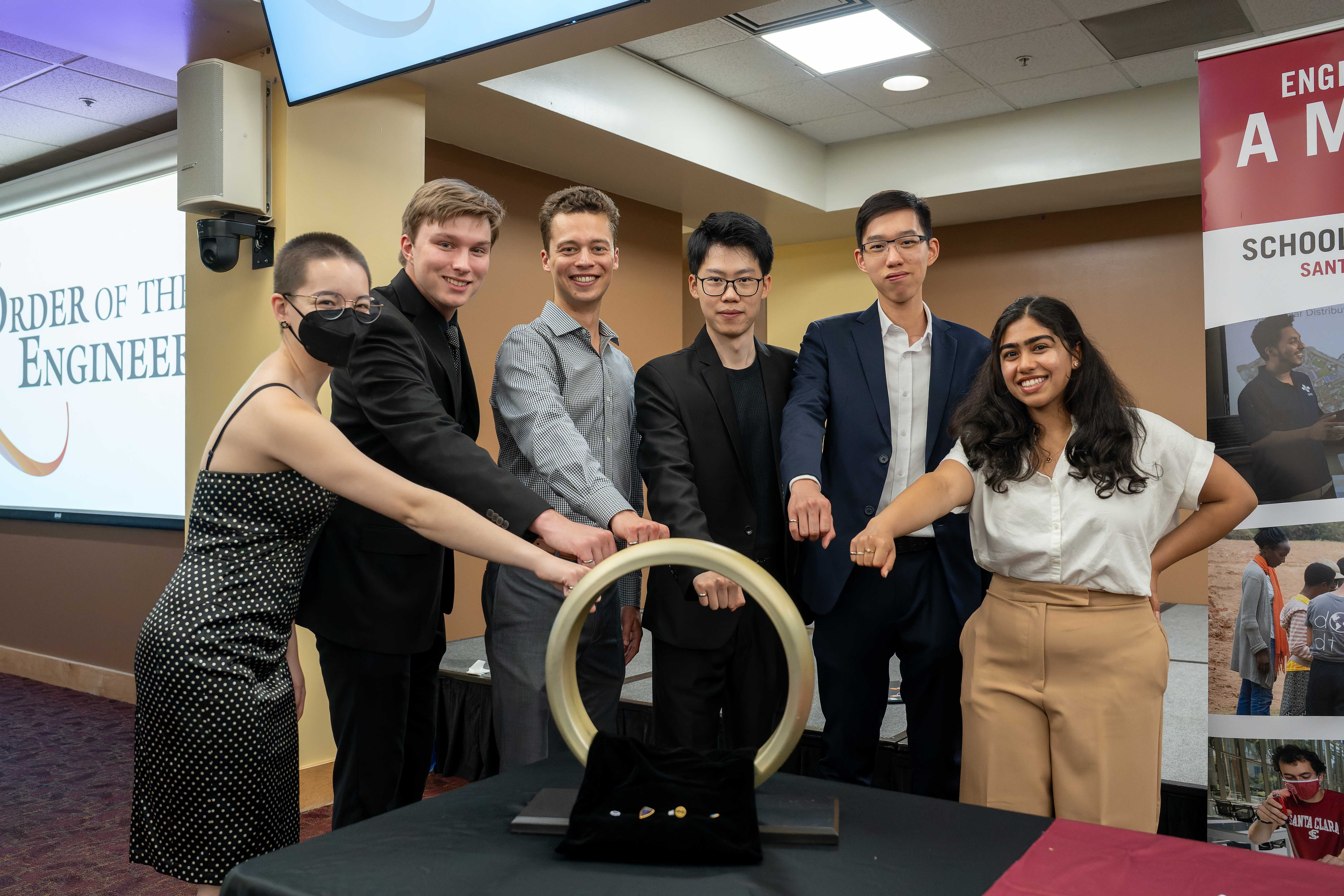 Students participating in the Order of the Engineer ceremony captured through the giant ring 