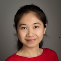 Portrait of Ying Liu smiling in a red shirt.