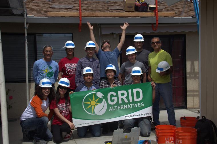 SCU engineering students pose with a GRID Alternatives banner image link to story