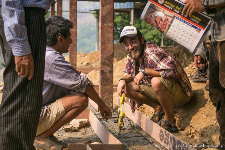 Scott Hanson ’14, right, on the job in Nepal.