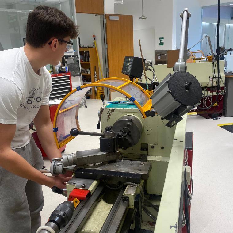 A photo of a student with the Robotic Arm Extrusion End Effector