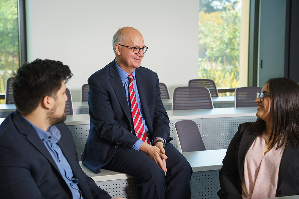 Dean with students in discussion 