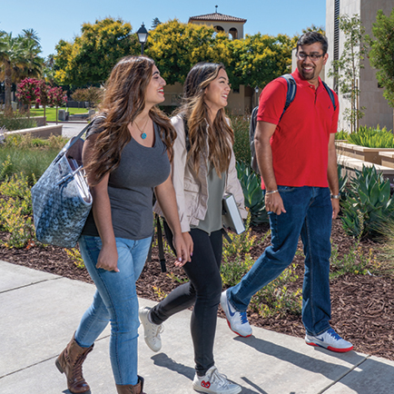 3 Students walking outside of Charney Hall 