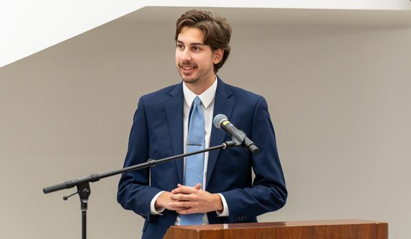 Student giving a talk at a lecturn 